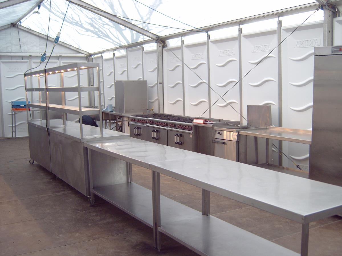 Spacious temporary marquee kitchen catering an a la carte restaurant at a horse racing event.